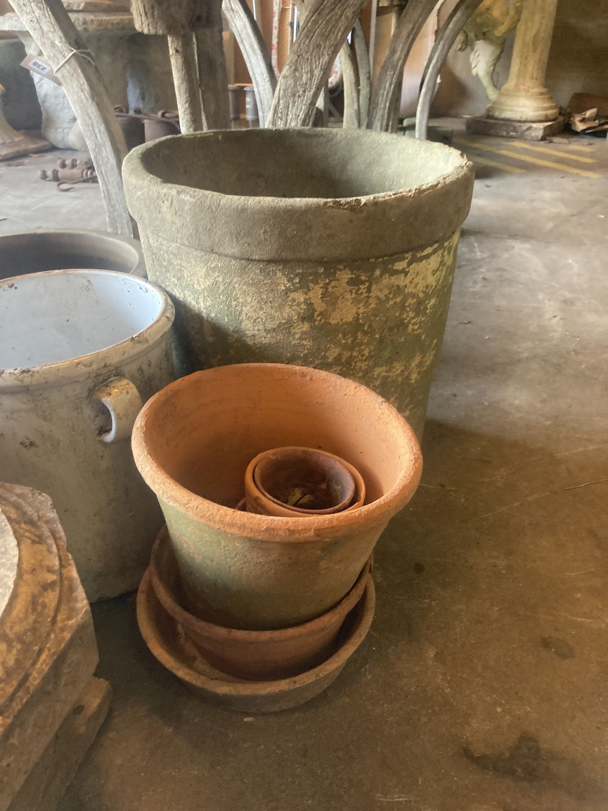 A quantity of assorted terracotta, glazed earthenware and metal garden planters together with a wirework basket, largest 40cm diameter